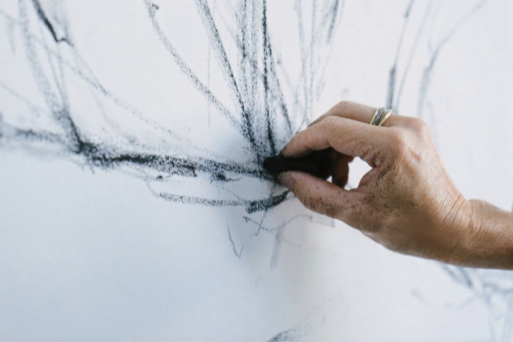 Artist drawing with charcoal — creative hand function